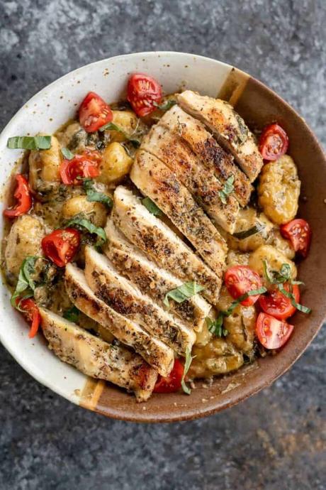 Pesto Chicken Gnocchi An overhead shot of pesto gnocchi in a bowl with sliced chicken