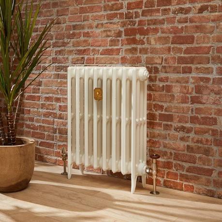 The 10 best column radiators for traditional and modern homes Milano Alice white classic cast iron column radiator on light wooden flooring in front of brick-effect wall