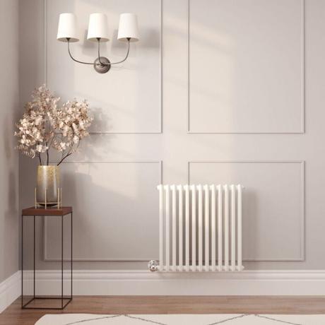 The 10 best column radiators for traditional and modern homes Milano Windsor white traditional horizontal electric double column radiator on light wall nearby gold vase beneath triple light fitting