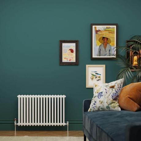 The 10 best column radiators for traditional and modern homes Milano Windsor white 3-column radiator on green wall nearby artwork and blue settee