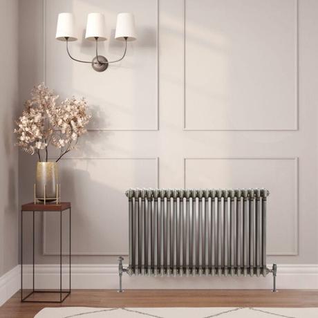 The 10 best column radiators for traditional and modern homes Milano Windsor lacquered raw metal traditional horizontal triple column radiator on light wall nearby table with gold vase beneath triple light fitting