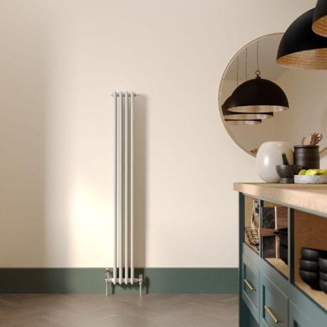 The 10 best column radiators for traditional and modern homes Milano Windsor vertical triple column white traditional cast iron style radiator on cream wall nearby large mirror in modern kitchen