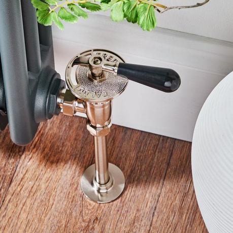 Why does my radiator keep turning off? Milano satin traditional thermostatic angled radiator valve and pipe set on wooden flooring attached to traditional radiator