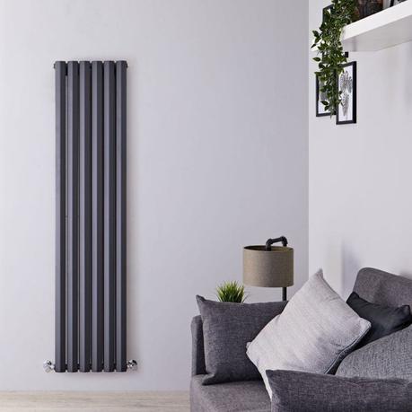 How much does it cost to install a heat pump? Milano Viti anthracite diamond panel vertical designer radiator on white wall nearby lamp and art covered with plants and gray settee