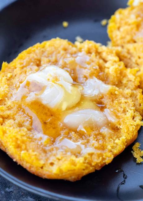 a very close up shot of pumpkin biscuits with honey and butter
