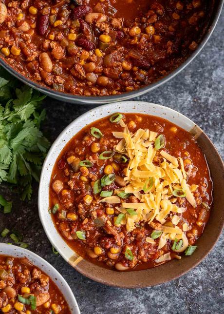 Chili Turkey Recipe an overhead shot of turkey chili in a bowl with cheddar cheese