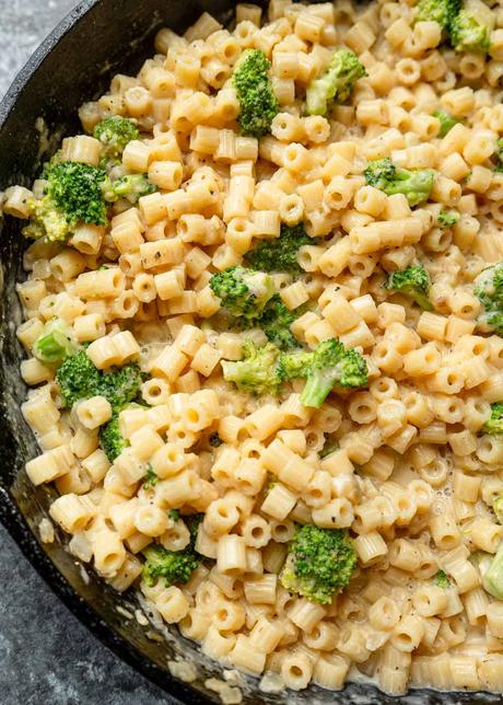 an overhead shot of broccoli pasta in a black skillet