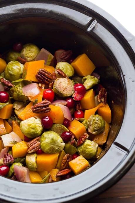 15+ Holiday Slow Cooker Recipes slow cooker filled with brussels sprouts cranberries butternut squash and pecans