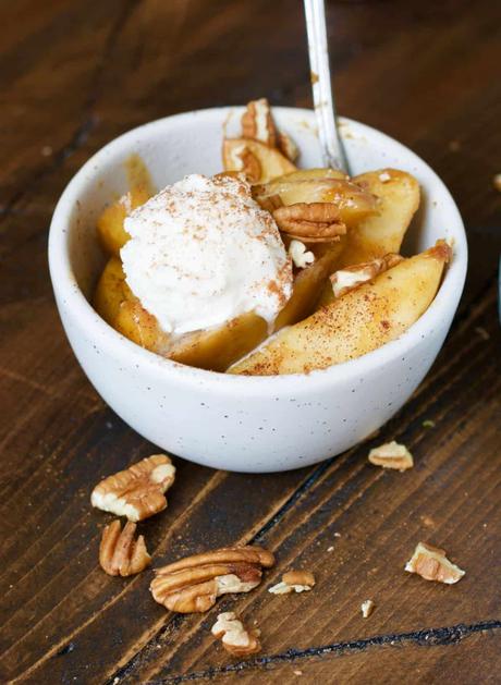 15+ Holiday Slow Cooker Recipes slow cooker apples in a bowl with a scoop of ice cream and a spoon