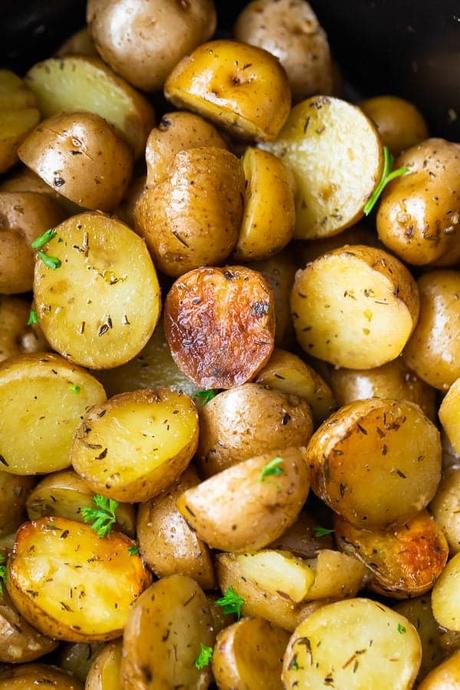 15+ Holiday Slow Cooker Recipes overhead shot of a pile of herb and olive oil crock pot potatoes