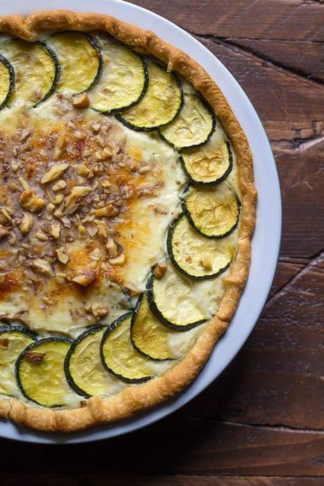 overhead shot of zucchini ricotta quiche with crumbled walnuts