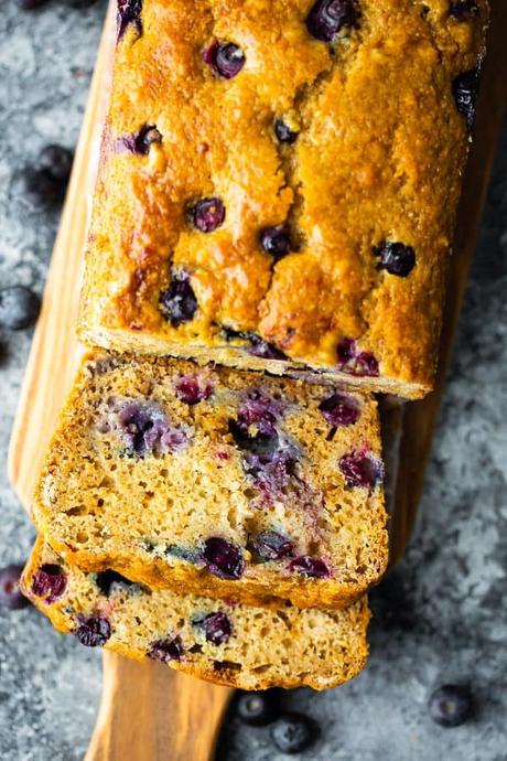 overhead shot of loaf of healthy blueberry bread with a few slices cut off