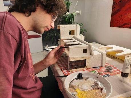 Making a Nativity diorama inside an antique steamer trunk: the first touch of color on the buildings