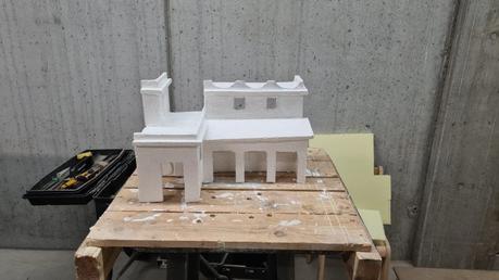Making a Nativity diorama inside an antique steamer trunk: buildings painted with a layer of white primer