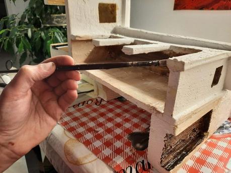 Making a Nativity diorama inside an antique steamer trunk: the first touch of color on the buildings