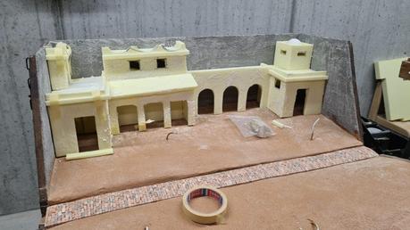 Making a Nativity diorama inside an antique steamer trunk: the foam houses in place