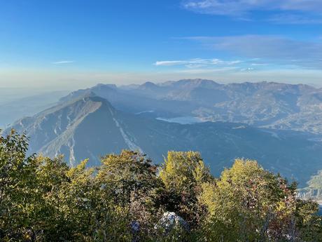 Panoramic view from Mount Tujanit’s peak showing rolling Albanian mountains under a bright blue sky. The dramatic landscape highlights why this lesser-known trail near Tirana is worth the effort.