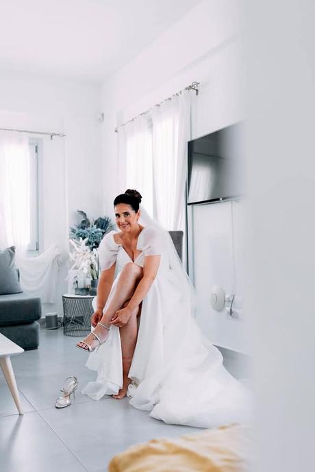 Summer Wedding In Oia With A Lush Floral Arch