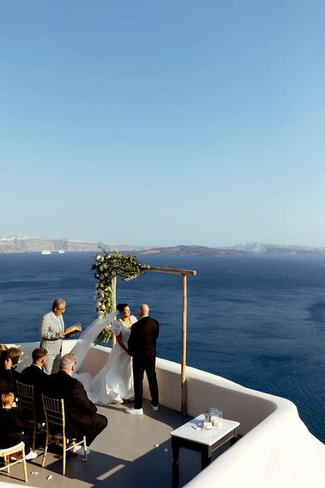 Summer Wedding In Oia With A Lush Floral Arch