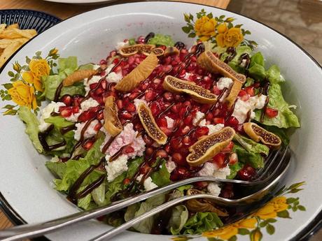 Fresh salad made with lettuce, ricotta, pomegranate seeds, figs, and balsamic glaze. A colourful Albanian salad balancing sweet and savoury tastes.