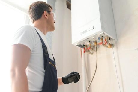 What size boiler do I need? A complete sizing guide Professional plumber wearing safety goggles checking a boiler and pipes