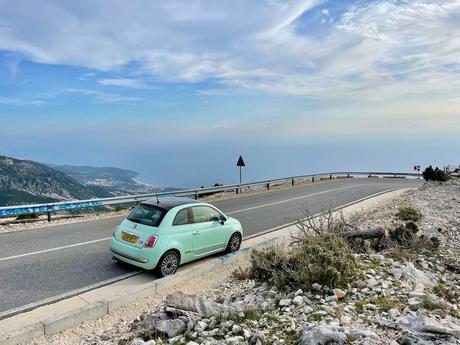 Ultimate Albania Itinerary For 1–3 Weeks of Adventure and Culture My green Fiat 500 car on the side of the road leading down to the Albanian riviera from the Llogara Pass