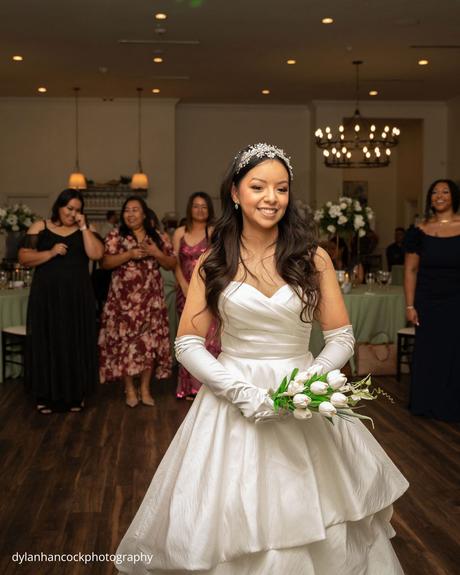 An Emerald & Sage, Zero-Alcohol Real Wedding bride prepares to throw bouquet as bridesmaids wait behind dylanhancockphotography