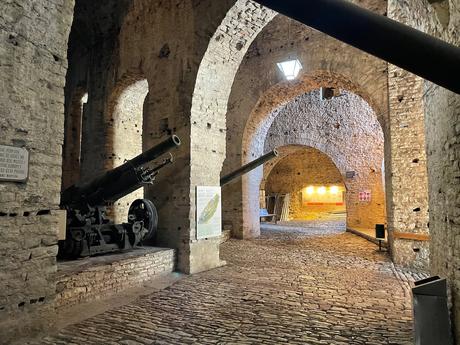 Vaulted stone passageways with cobbled floor and lined with cannons inside Gjirokaster castle