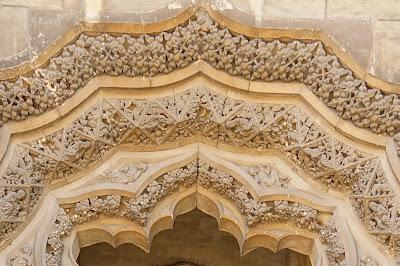 Photo showing detail of the carving in the previous image, including stylised foliage.