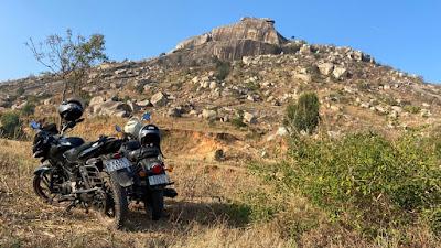 Bikes resting peacefully in fields at the base of Hiregundagal betta