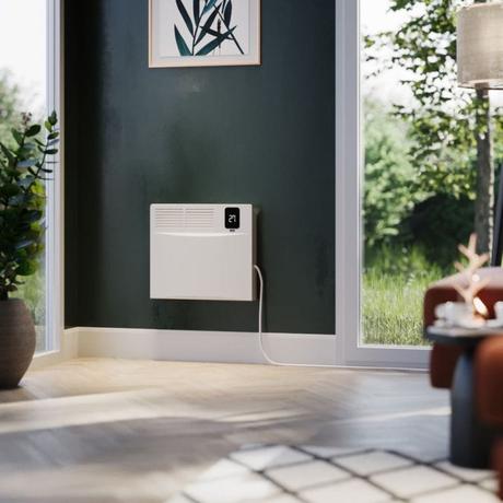 ECOSO Elio white smart electric convector panel heater on dark green wall beneath framed artwork