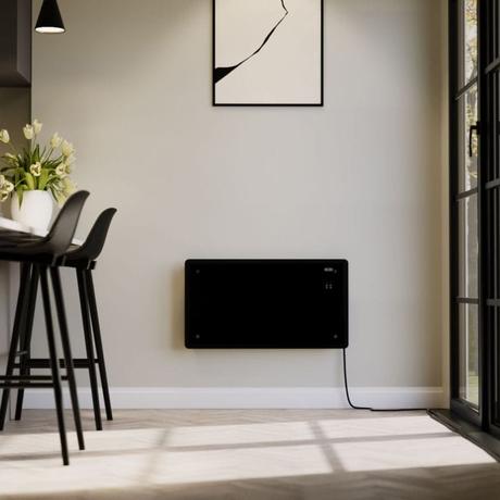 ECOSO Vitrum black smart electric glass panel portable heater on light beige wall beneath framed artwork in modern home