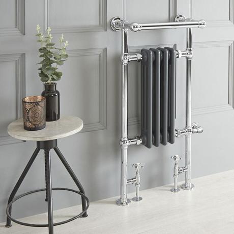 Milano Elizabeth anthracite traditional dual fuel heated towel rail on gray wall nearby small table with candle and vase