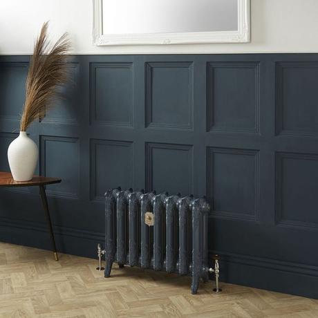 8 radiator ideas for period properties Milano Beatrix Farrow & Ball hague blue 2 column cast iron radiator in front of blue wall nearby small table with vase