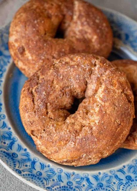 close up, overhead image of cinnamon protein bagels on a blue plate