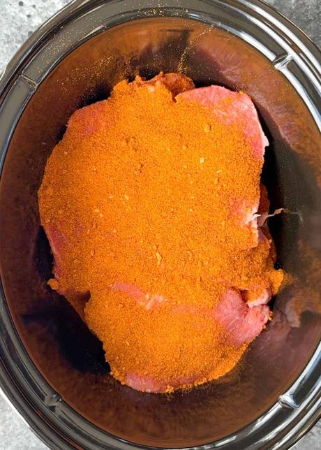 Shredded Beef Tacos beef chuck roast covered in taco seasoning in a crock pot