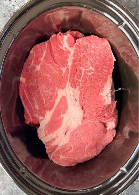 Shredded Beef Tacos a large chuck roast in a slow cooker