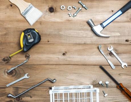 A selection of various tools used in restoring radiators on wooden surface