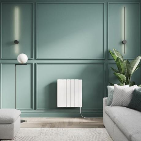 ECOSO Tuc white ceramic core smart electric heater on green wall nearby large houseplant and light gray settee