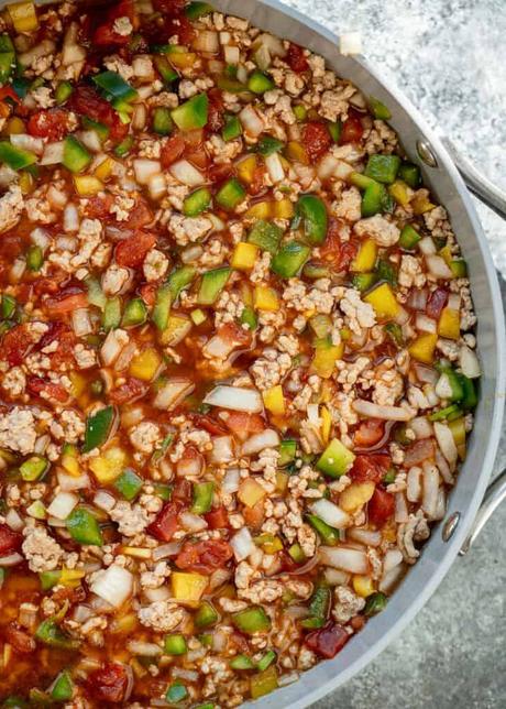 ground beef, sauteed veggies, tomatoes, and uncooked rice mixed in a large skillet