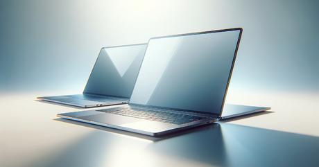 Two MacBook laptops positioned side-by-side at complementary angles on a pure wh