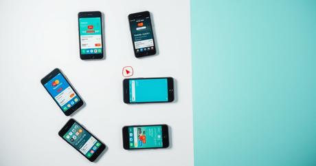 A striking overhead shot of multiple smartphones and tablets arranged in a preci