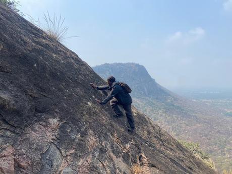 Sippy ascending a very steep rock face on Vade Malleshwara Gudi betta trek