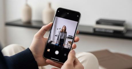 A professional conference room scene with multiple smartphones and tablets scatt