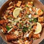 an overhead shot of hot honey halloumi salad in a brown bowl