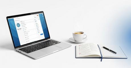 A clean workspace scene showing an open MacBook Pro displaying the WordPress das