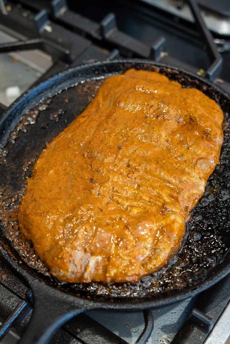Carne Asada Tacos uncooked carne asada in cast iron skillet