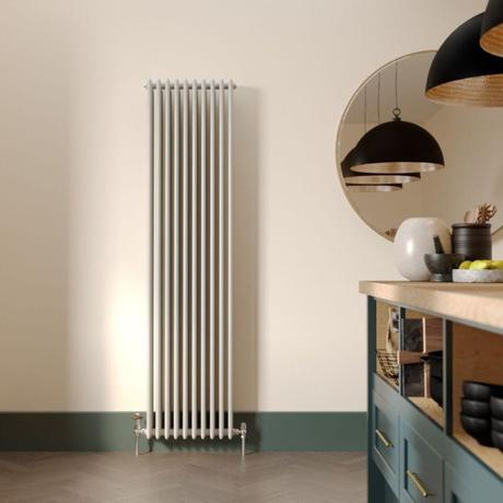 Milano Windsor white vertical traditional 4 column radiator on light wall nearby large mirror and modern countertop