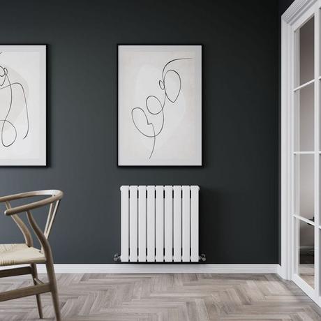 Milano Erin white flat double panel horizontal designer convector radiator on dark wall beneath framed black and white artwork nearby white framed door