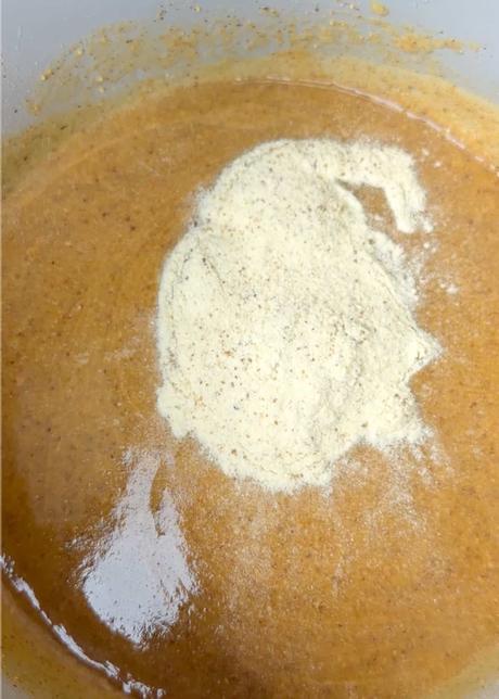 Dark Chocolate Cherry Granola Bars almond butter and protein powder in a mixing bowl